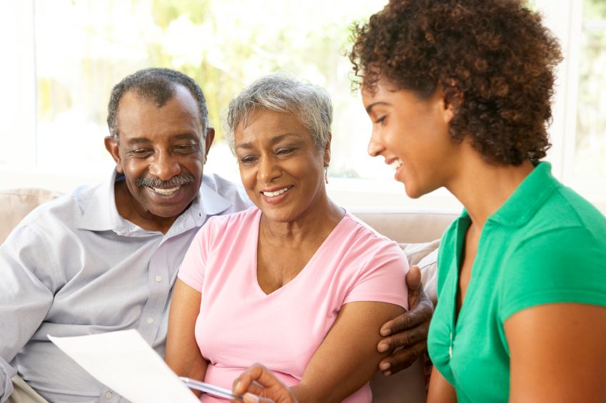 Family discussing paperwork together on couch